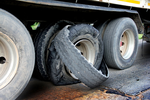 A closeup of a semi-truck tire blowout