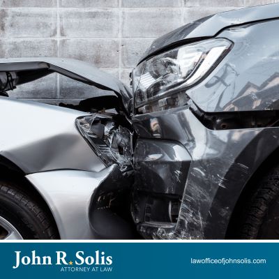 Two grey cars with front end damage after a Laredo car accident