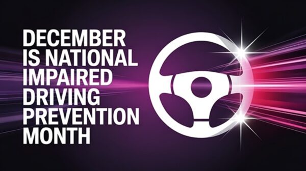 A graphic for National Impaired Driving Prevention Month in December featuring a white steering wheel icon on a dark purple background with pink light streaks.