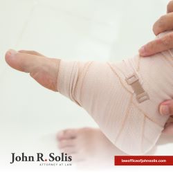 An injury victim with a bandaged foot after an accident in Laredo, TX caused by negligence