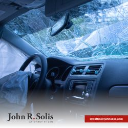 A car with a deployed airbag and broken windshield after a car accident in Laredo