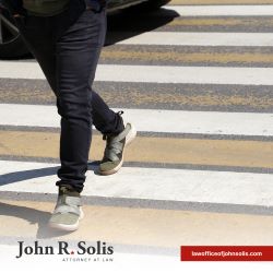 A pedestrian walking across the street in a crosswalk in Laredo, TX