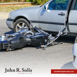A motorcycle laying on its side in the road after a motorcycle accident in Laredo